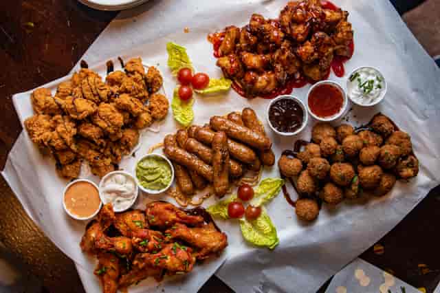 Vibrant appetizers for casual networking at The Brewery Tap, featuring chicken bites and dips.