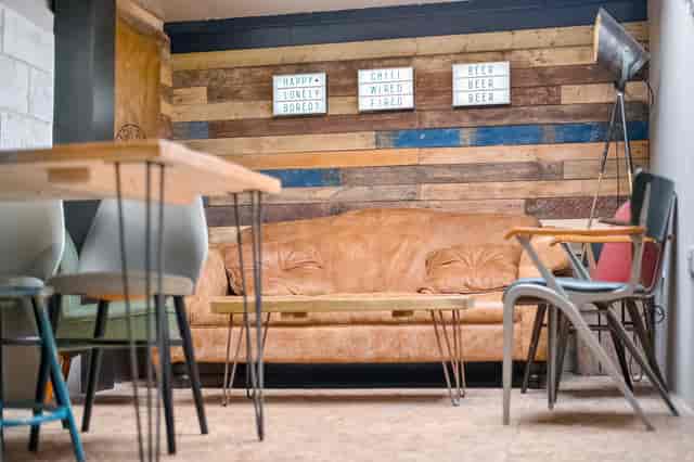 Cozy Taproom at Sambrook's Brewery with leather couch, ideal for meetings and workshops.