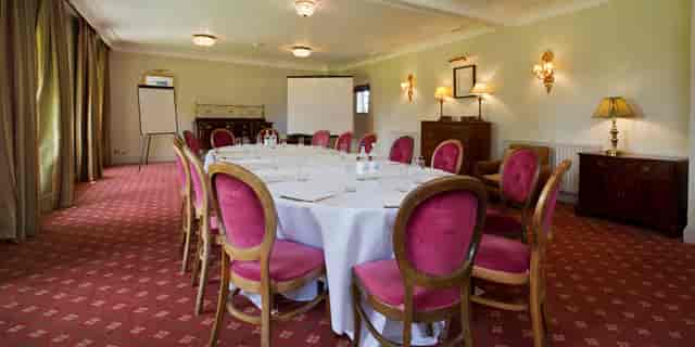Abberley Suite meeting room with round table, ideal for workshops and gatherings.