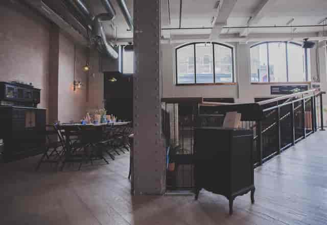 Versatile event space at Pacifica Burger & Cocktail Bar with natural light, ideal for gatherings.