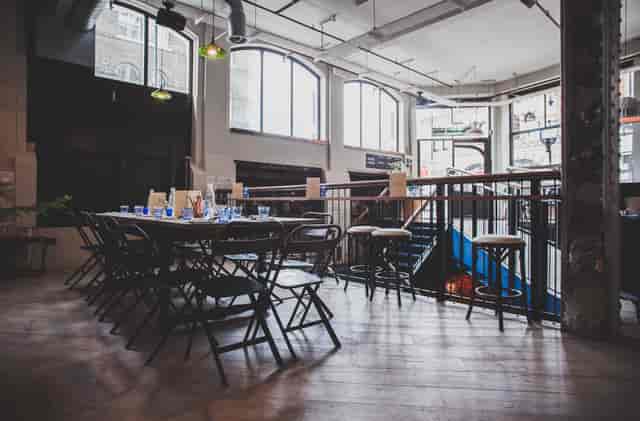 Versatile event space at Pacifica Burger & Cocktail Bar with natural light for gatherings.