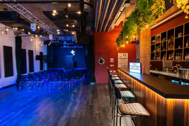 Versatile event space in Tileyard London with sleek bar and intimate stage setup.
