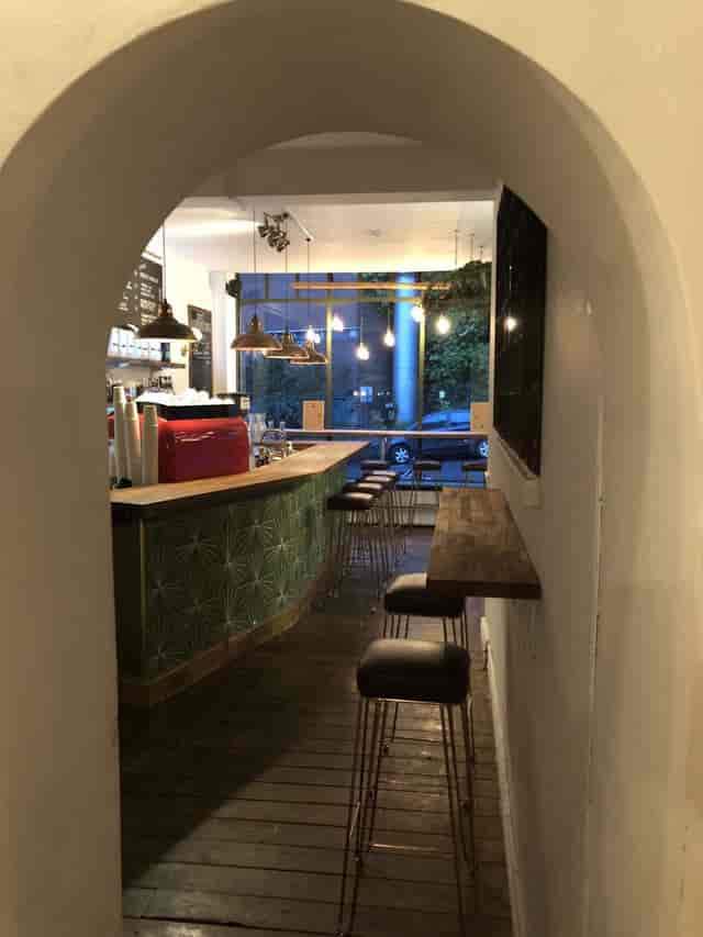 Cozy café venue in Archie's with stylish bar, ideal for informal meetings and events.