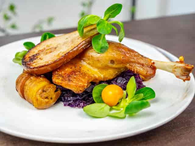 Elegant roasted chicken dish with vibrant vegetables at Champagne Route event.