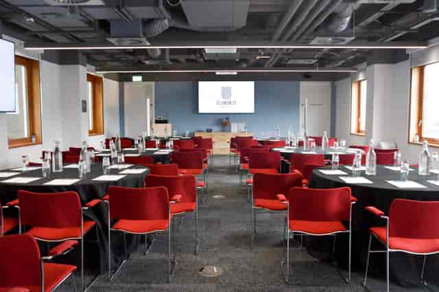 Modern meeting room, round tables, corporate event, presentation space