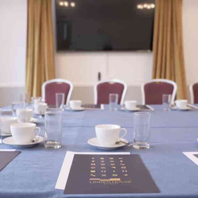 Captains Room at Linden House: elegant meeting space with organized table settings for events.