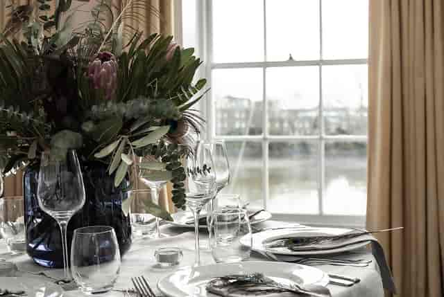Elegant dining table with floral centerpiece in Commodores Room, perfect for events.