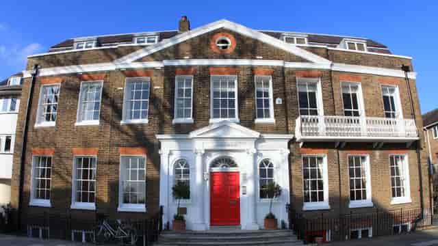 Historic Linden House Boardroom with striking red door, perfect for meetings and events.