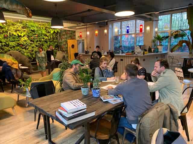 Vibrant Use.Cafe meeting space with casual seating for workshops and networking.