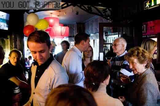 Lively networking event at Hotel Pelirocco with colorful decor and engaged attendees.