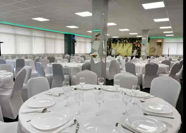 Elegant ACAA Hall banquet setup with floral backdrop for weddings and corporate events.