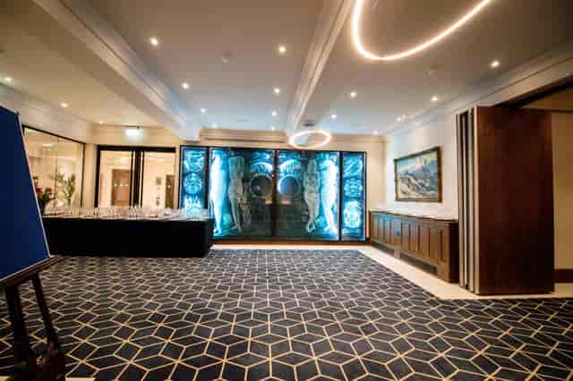 Sophisticated event space at 87 Barts Close with blue backlit display, ideal for receptions.