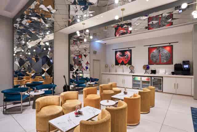 Modern BACKSTAGE After Party Bar with mirrored ceiling, perfect for networking events.