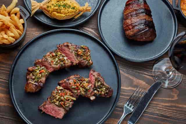 Whiskey Room dining setup with steaks, wine for upscale meetings and celebratory dinners.
