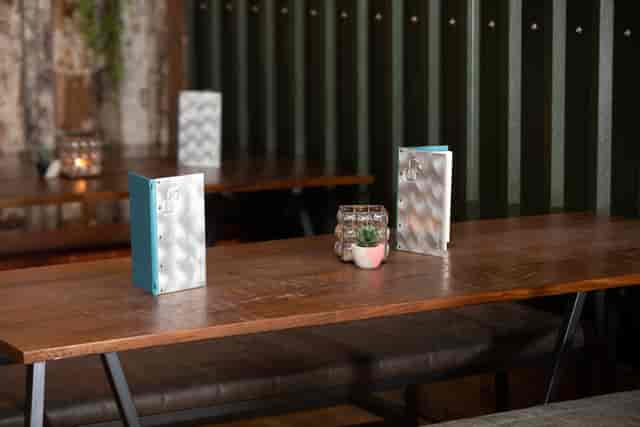 "Elegant meeting table setup with rustic decor at Foundry Project restaurant."