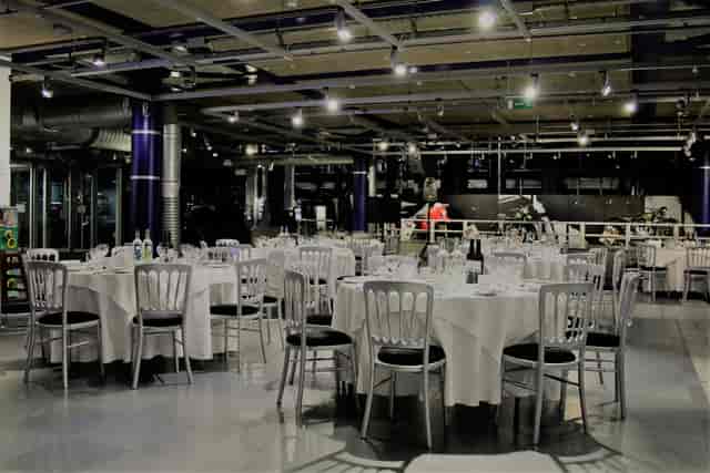 Elegant dinner setup at Past Gallery, featuring round tables and sophisticated ambiance.