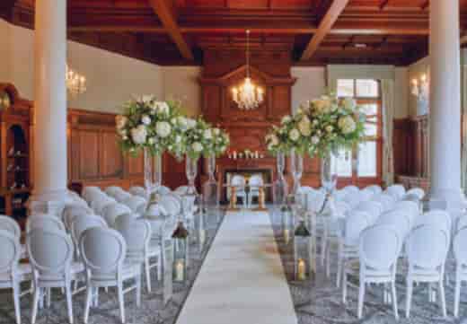 Elegant wedding ceremony in Oak room, The Principal York with floral arrangements.
