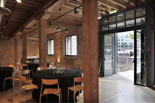 Rum Store event space with round tables, ideal for corporate meetings and social gatherings.