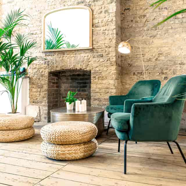 Stylish lounge area with plush green chairs for networking events at Cobalance Cafe.