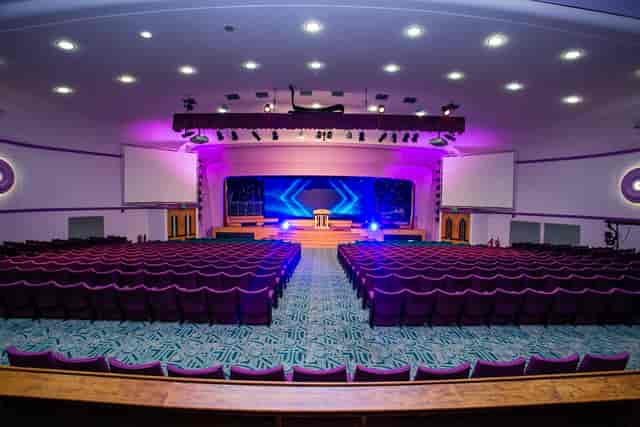 Spacious conference hall with plush seating, ideal for impactful meetings and events.