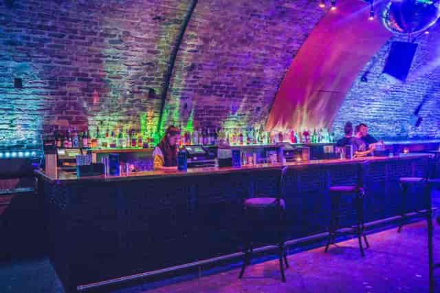 Stylish bar with exposed brick, ideal for networking events and cocktail receptions.