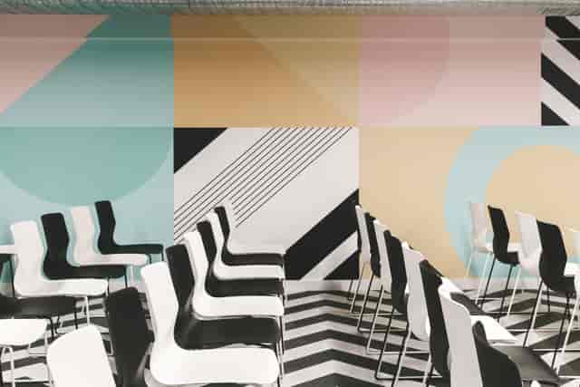 Modern event space in Huckletree Ancoats with vibrant geometric wall design.