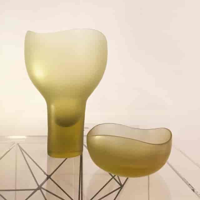 Sleek green glass vase and bowl centerpiece for upscale events and gatherings.