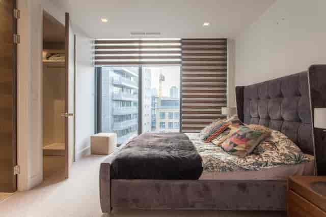 Modern penthouse venue with plush bed, ideal for filming and day events.