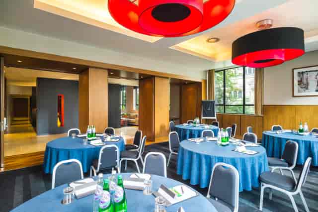 City Suite meeting room with blue tablecloths, ideal for workshops and conferences.