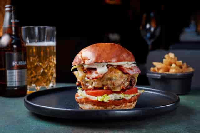 Gourmet burger with fries and beer at Gaucho Chancery Lane for events and catering.