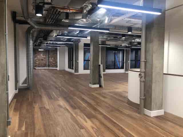 Spacious modern venue with polished floors for corporate events and workshops.