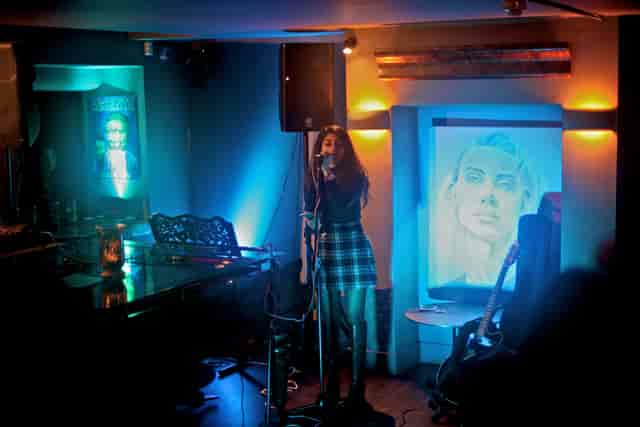 Intimate live music venue with cozy lighting at Sandy's Piano Bar.