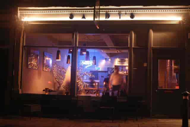 Stylish basement venue with warm lighting for intimate gatherings and networking events.