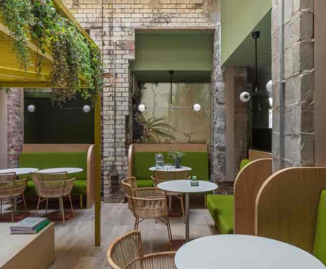 Modern coworking space with cozy booths for networking and casual meetings in Whitworth Locke.