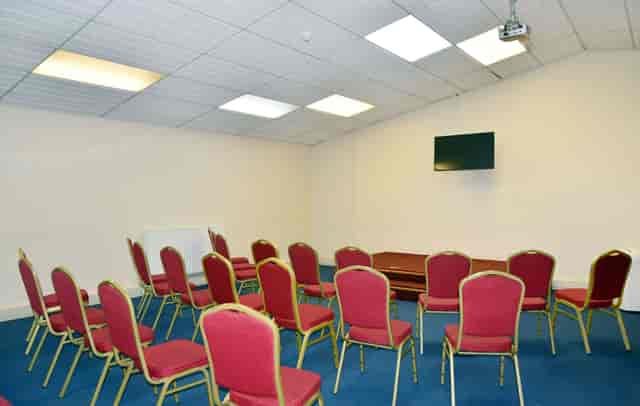 Mitcham Business Event Centre meeting room with red chairs for presentations and gatherings.