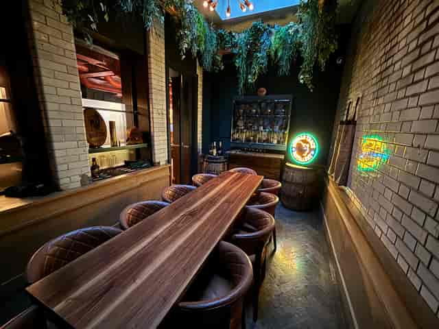 Private dining room at The Wren Tavern with a long wooden table, ideal for meetings and events.