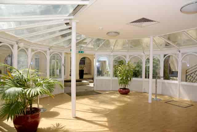 Bright Garden Room at SCI Belgravia, ideal for meetings and gatherings with natural light.
