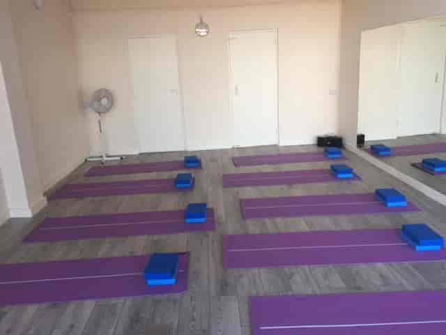 Serene yoga studio with purple mats, ideal for wellness retreats and team-building events.