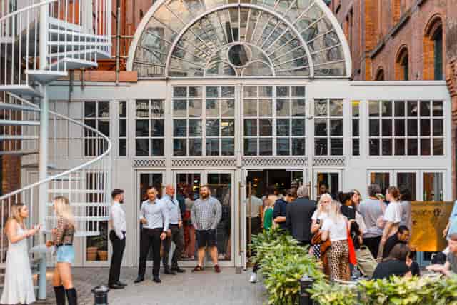 Vibrant Conservatory Bar entrance at The Cotton Factory, perfect for networking events.