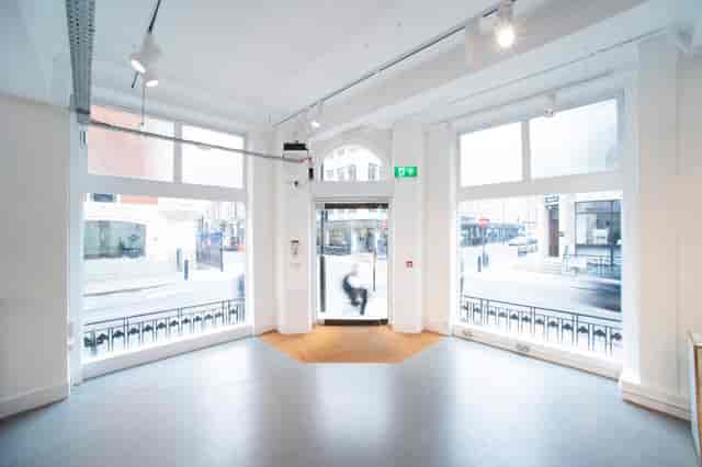 Bright event space with large windows at Whole Venue, ideal for meetings and workshops.