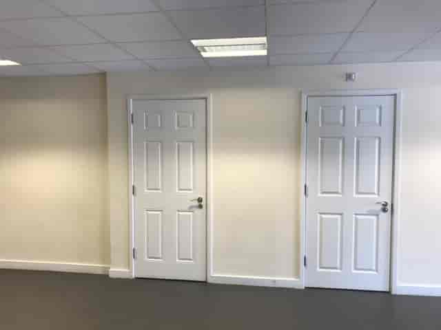 Main Hall in Savoy Court with blank wall and closed doors, perfect for versatile events.