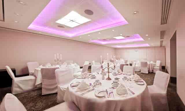Langham Suite at Langham Court Hotel, elegant dinner setup with purple lighting.