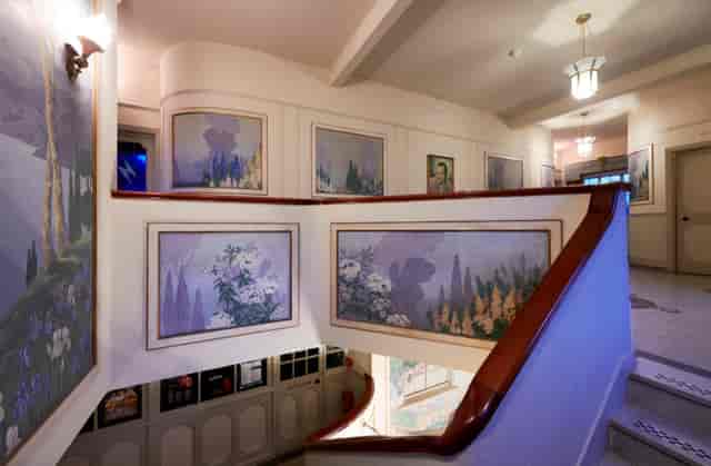 Elegant staircase with murals at Bridport Electric Palace, perfect for networking events.