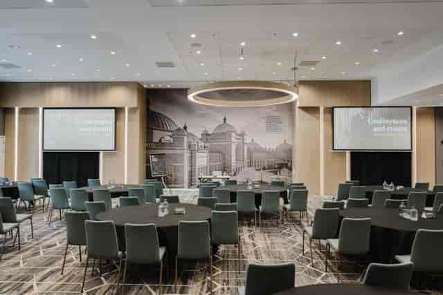 Modern Fry Suite conference room with round tables, ideal for events and presentations.