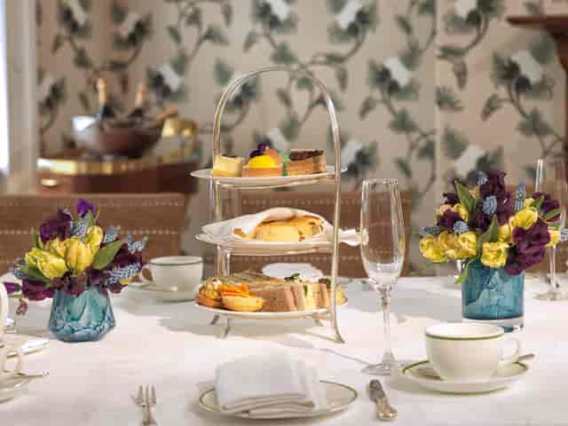 Lord Byron at Brown's Hotel, elegant afternoon tea with pastries and fine china.