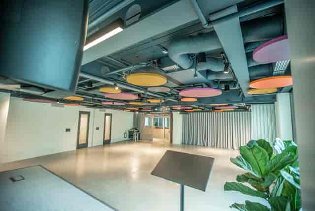Modern business lounge with colorful acoustic panels for meetings and social events.