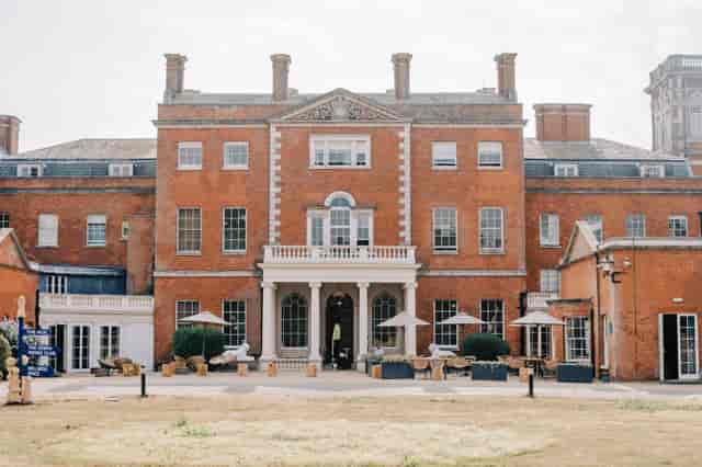 Evelyn at upscale venue with red brick facade, ideal for corporate events and gatherings.