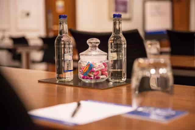 Boardroom setup at Thistle Holborn with water and candy for meetings.