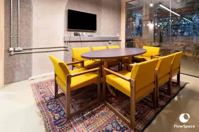 Modern Mentmore Meeting Room with round table and yellow chairs for collaborative sessions.