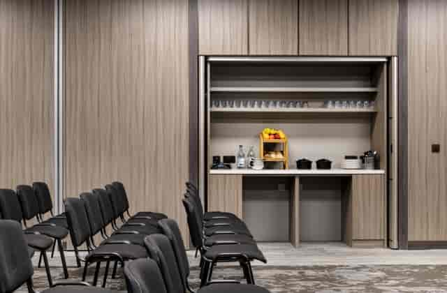 Breakout room with refreshment station at AC Marriott Manchester City Centre for corporate meetings.